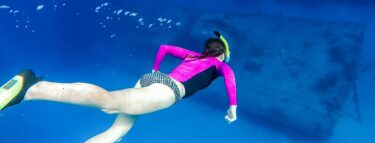 cayman brac girl snorkling over wreck 1060x403 min